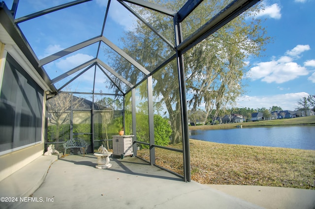 unfurnished sunroom with a water view