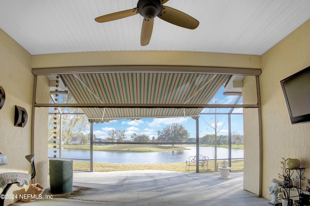 garage featuring a water view and ceiling fan