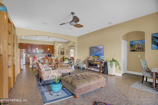 tiled living room with ceiling fan