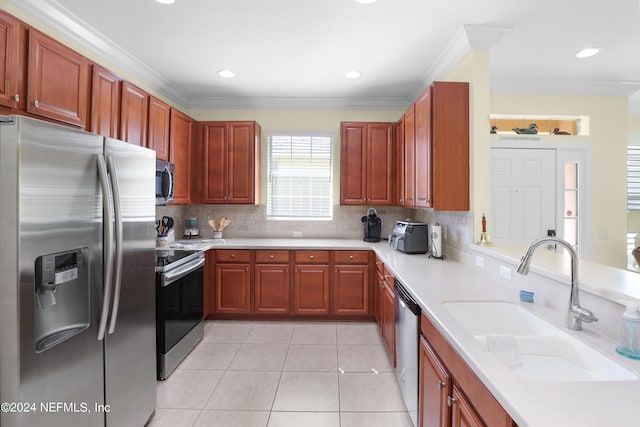 kitchen featuring sink, light tile patterned floors, ornamental molding, appliances with stainless steel finishes, and backsplash