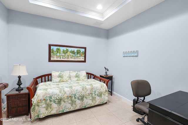 tiled bedroom featuring crown molding and a tray ceiling