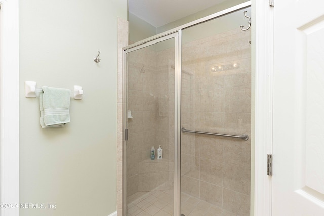 bathroom with a shower with shower door