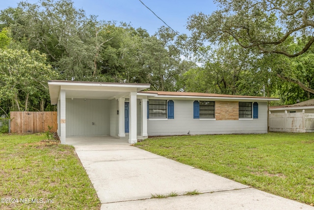 single story home featuring a carport and a front lawn