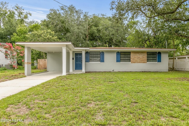 single story home featuring a carport and a front yard