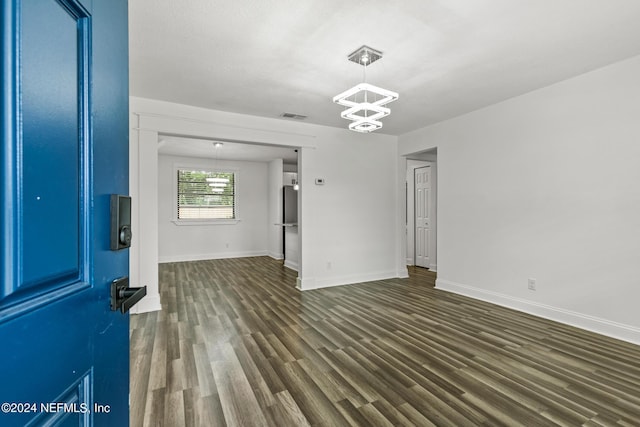 interior space featuring a notable chandelier and dark hardwood / wood-style floors