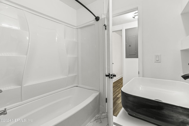 bathroom featuring shower / tub combination and electric panel