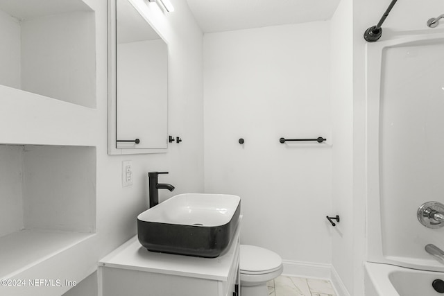 full bathroom with toilet, vanity, and  shower combination