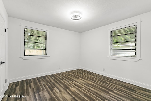 empty room featuring dark hardwood / wood-style flooring