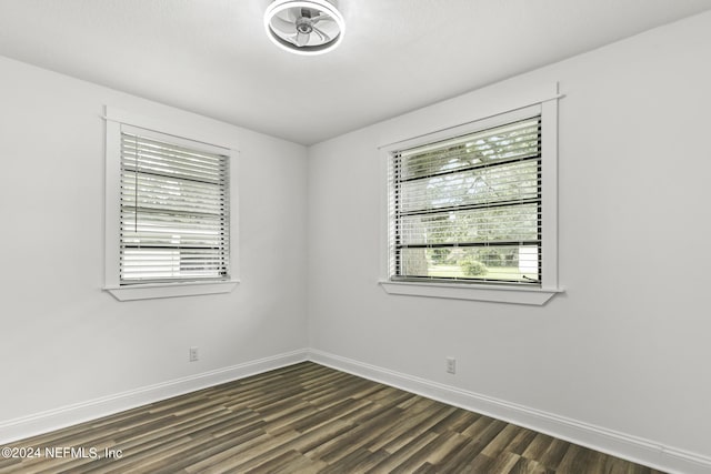 empty room with dark hardwood / wood-style flooring