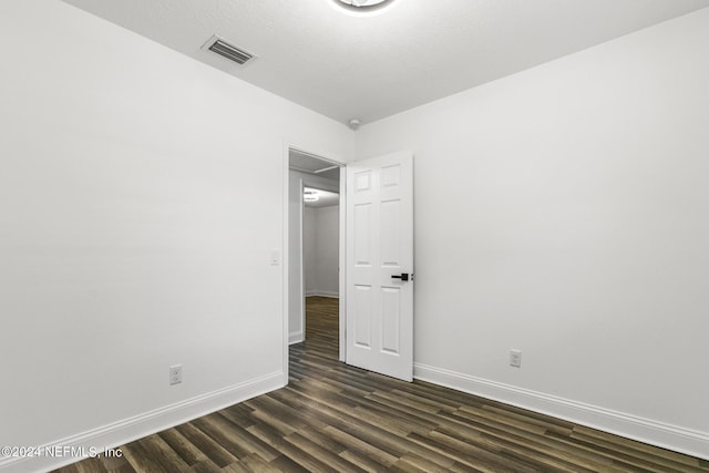 empty room featuring dark hardwood / wood-style floors