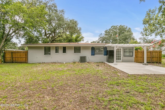 back of property with a pergola, a yard, central AC, and a patio area