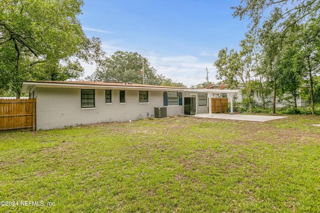 rear view of house with a yard, central AC, and a patio area