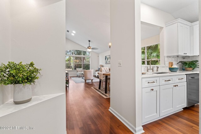 hall with sink, lofted ceiling, and dark wood-type flooring