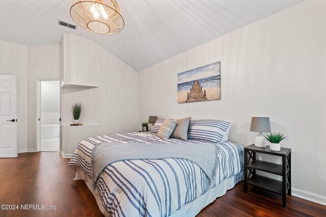 bedroom with dark hardwood / wood-style flooring and vaulted ceiling