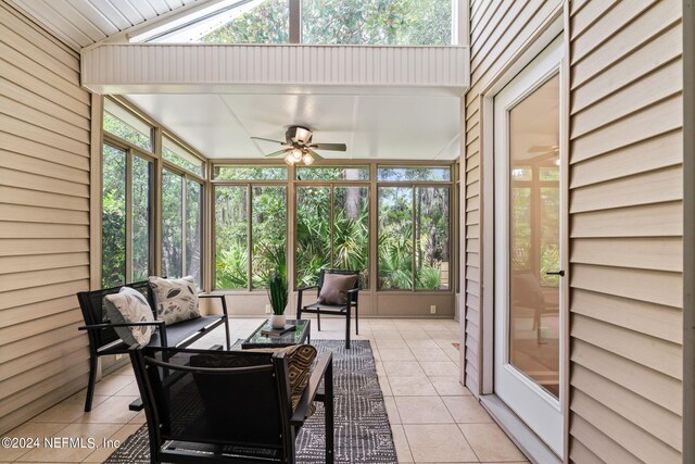 sunroom / solarium with lofted ceiling and ceiling fan