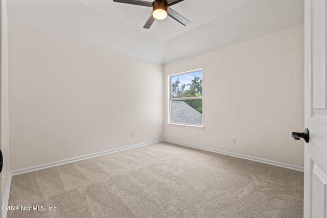 spare room featuring ceiling fan and light colored carpet