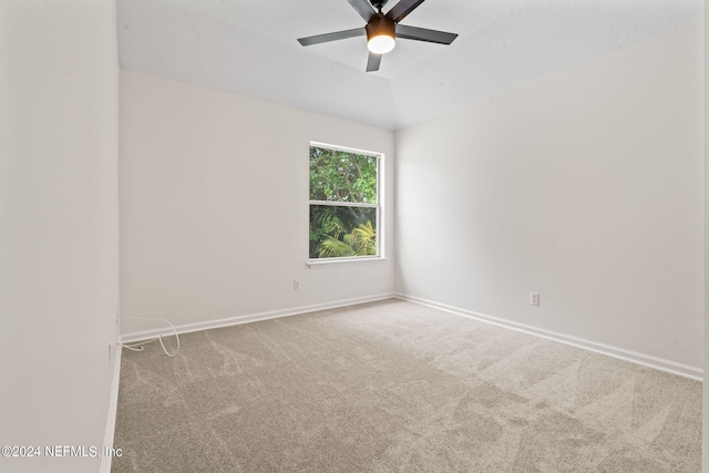 carpeted spare room with ceiling fan