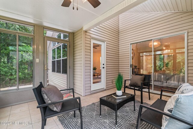 sunroom / solarium with vaulted ceiling, ceiling fan, and a wealth of natural light