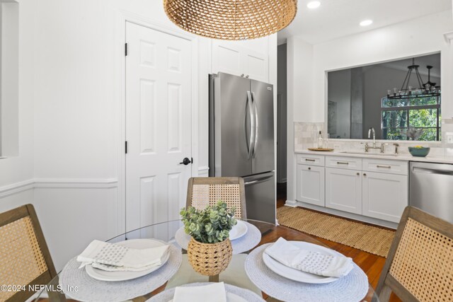 dining room with sink and wood-type flooring