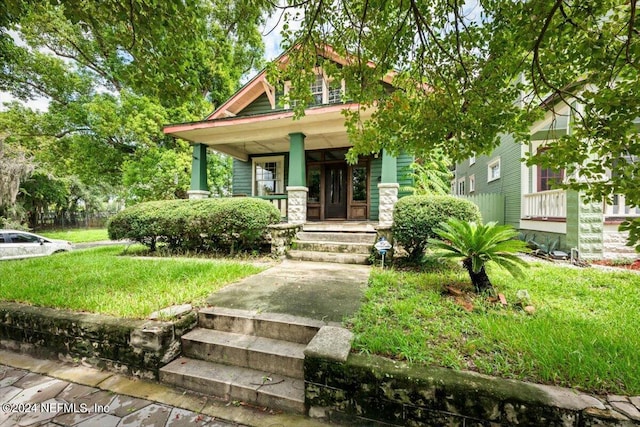 view of front facade with a porch and a front lawn