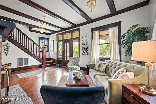 living area featuring visible vents, stairway, wood finished floors, beamed ceiling, and baseboards