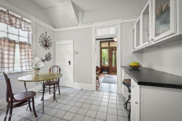 dining room with light tile patterned floors and baseboards