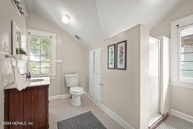 full bathroom with a stall shower, visible vents, toilet, vaulted ceiling, and vanity