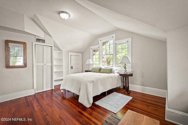 bedroom with baseboards, visible vents, multiple windows, and wood finished floors