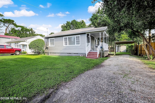 view of front of property featuring a carport and a front lawn