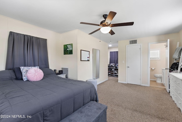 carpeted bedroom with ceiling fan and ensuite bathroom