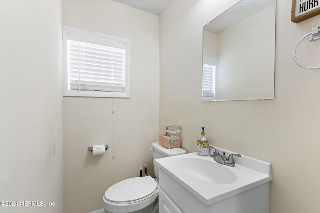 bathroom featuring toilet and vanity