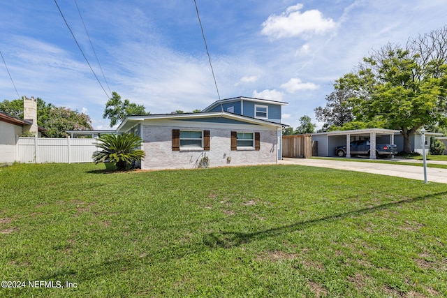 view of front of property with a front yard and a carport