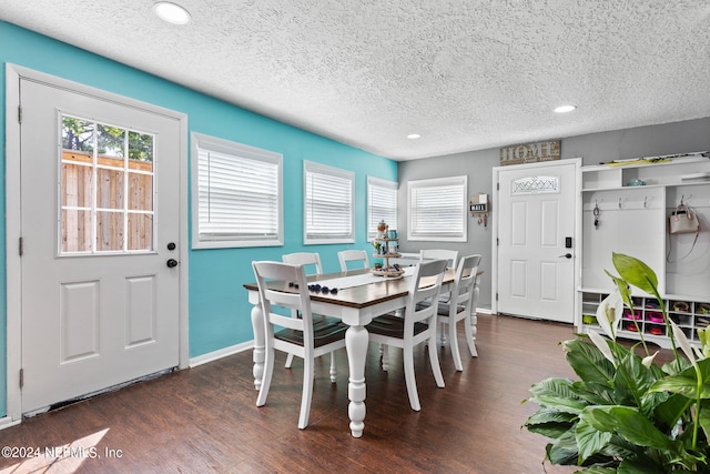 dining area featuring a textured ceiling, a wealth of natural light, and dark hardwood / wood-style flooring