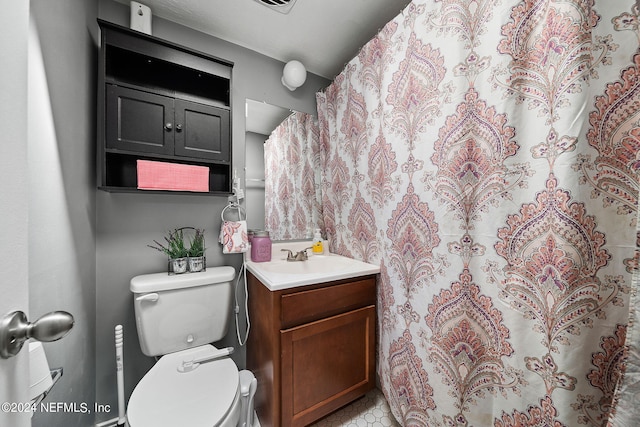 bathroom with toilet and vanity