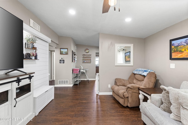 living room with ceiling fan and dark hardwood / wood-style floors