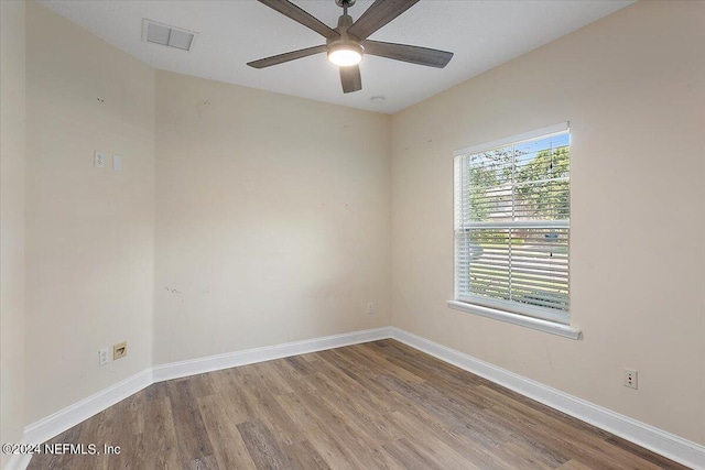 empty room featuring hardwood / wood-style floors and ceiling fan