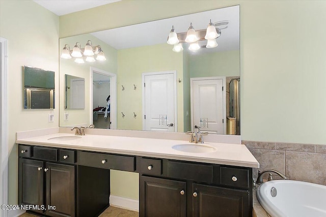 bathroom with vanity, tile patterned flooring, and plus walk in shower