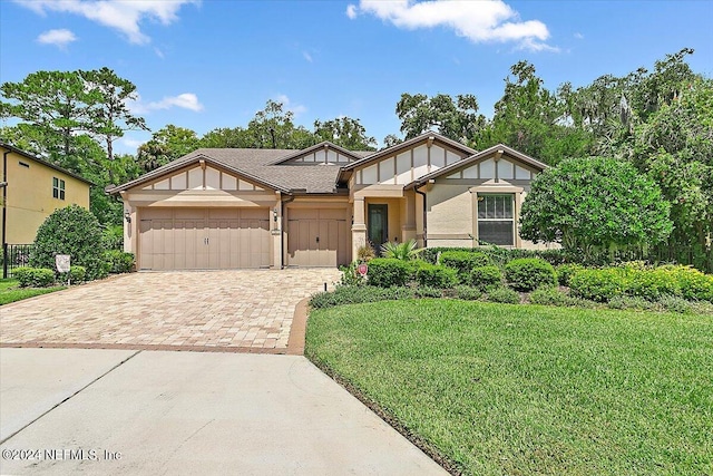 view of front of house featuring a garage and a front lawn