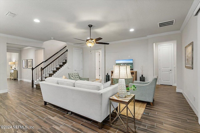 living room with ceiling fan, a textured ceiling, and ornamental molding