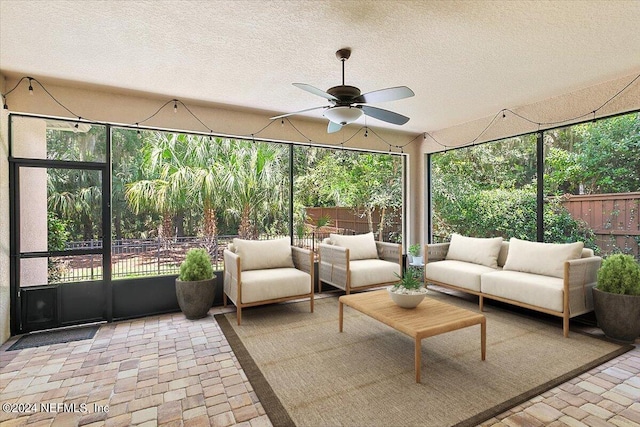 sunroom / solarium featuring ceiling fan