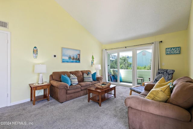 carpeted living room with high vaulted ceiling