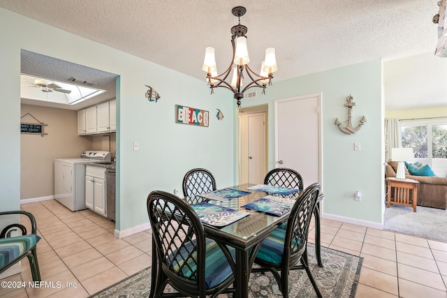 dining area with a textured ceiling, light tile patterned floors, and washer / clothes dryer