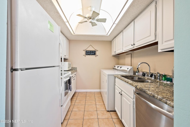 washroom featuring light tile patterned floors, baseboards, laundry area, ceiling fan, and a sink