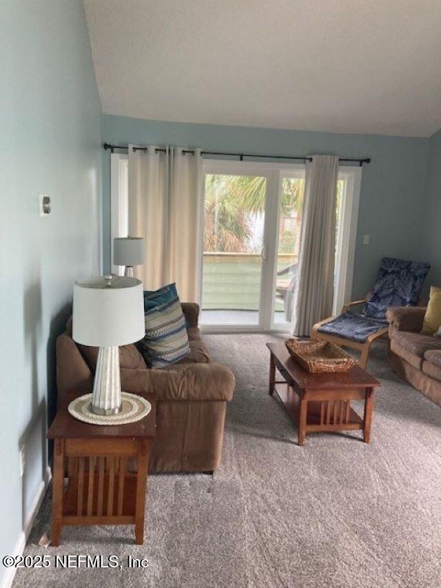 living room with lofted ceiling and carpet