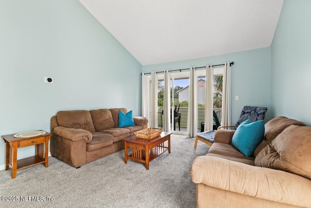 living room featuring light carpet and high vaulted ceiling