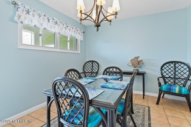 dining room featuring baseboards, a notable chandelier, and light tile patterned floors