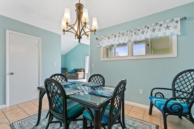 dining area featuring a textured ceiling, tile patterned flooring, and a notable chandelier