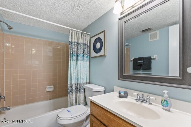 bathroom featuring a textured ceiling, toilet, visible vents, shower / bath combo with shower curtain, and vanity