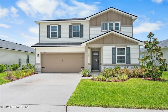 craftsman house featuring a garage and a front lawn