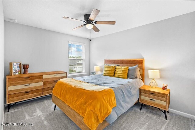 carpeted bedroom featuring ceiling fan